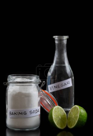 Photo for Baking soda, vinegar and cut lemons on blac table, flat lay. Space for text - Royalty Free Image
