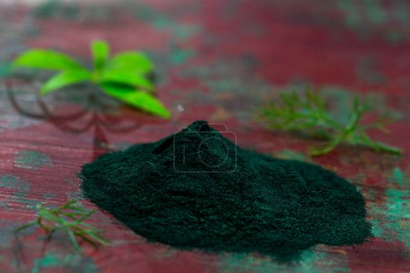 Photo for Organic green spirulina powder top view wooden background. Super foods, food supplement - Royalty Free Image