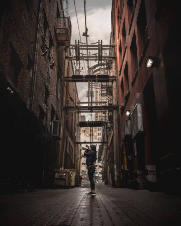 girl taking photo in alley