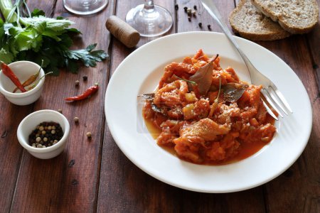 Italienisches Essen. Rinderkutteln mit Tomatensauce in einem weißen Teller auf rustikalem Tisch. Direkt darüber.