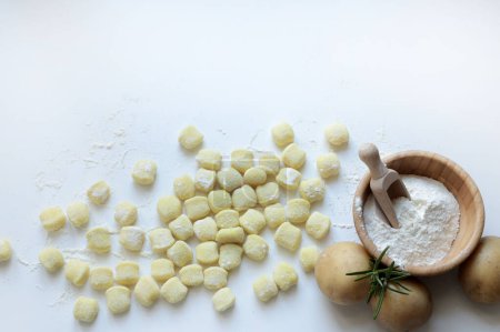 Photo for Italian food, potato gnocchi. Raw uncooked potato gnocchi isolated on white background. Overhead view. Home cooking concept. - Royalty Free Image
