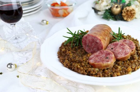 Photo for Cotechino with lentils served on a plate isolated on white background. Christmas decorations. Christmas holiday. Italian food concept. Overhead view. - Royalty Free Image