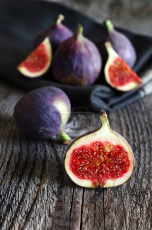 Fresh figs isolated on wooden background. Overhead view. Vegetarian food. Copy space.