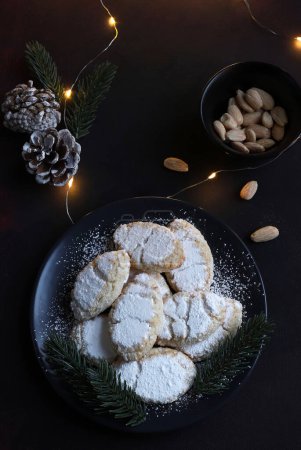 Photo for Ricciarelli pastries, typical Sienese Christmas sweet made with almond on dark background. Christmas decorations. Traditional Italian desserts. - Royalty Free Image