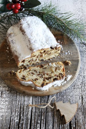 Traditional Christmas german dessert Stollen also known as Christstollen cut into pieces. Sweet leavened dough with spices, candied fruit and dried fruit. 