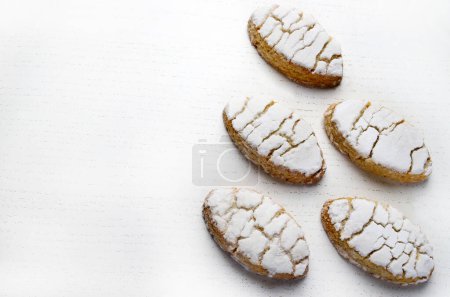 Ricciarelli pastries, typical Sienese Christmas sweet made with almond on white background. Christmas decorations. Traditional Italian desserts. Copy space.