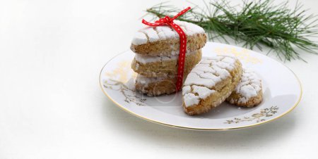 Ricciarelli pastries, typical Sienese Christmas sweet made with almond on white background. Christmas decorations. Traditional Italian desserts. Copy space.