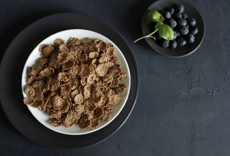 Wholemeal breakfast cereals rich in fiber isolated on gray background. Healthy food. Copy space.