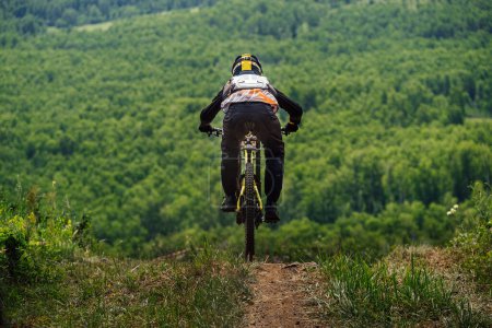 Téléchargez les photos : Green Glade, Russia - July 16, 2022: athlete rider downhill forest trail race in Ural Downhill Cup - en image libre de droit