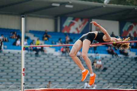 Téléchargez les photos : Chelyabinsk, Russia - June 23, 2022: female athlete high jump on background fan stands in Athletics Championship - en image libre de droit
