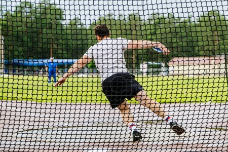 Photo for Male athlete attempt in discus throwing - Royalty Free Image