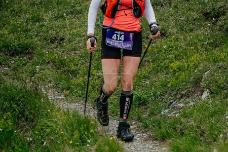Photo for Arkhyz, Russia - July 2, 2022: female athlete walking mountain trail in Arkhyz X Run - Royalty Free Image