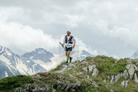 Photo for Arkhyz, Russia - July 2, 2022: male athlete running mountain trail in Arkhyz X Run - Royalty Free Image