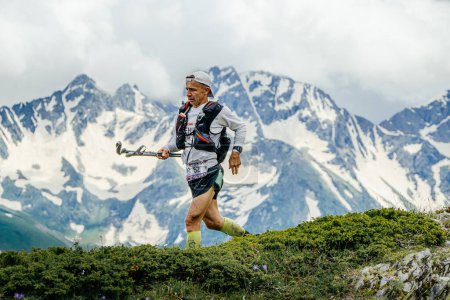 Photo for Arkhyz, Russia - July 2, 2022: male athlete running mountain trail in Arkhyz X Run - Royalty Free Image