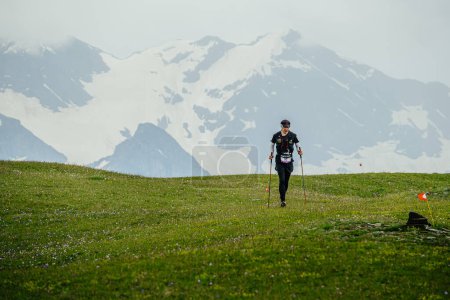 Photo for Arkhyz, Russia - July 2, 2022: male athlete walking mountain trail in Arkhyz X Run - Royalty Free Image