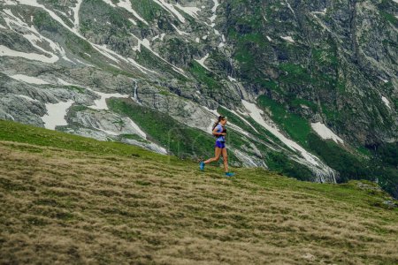 Photo for Arkhyz, Russia - July 2, 2022: female runner run trail down mountain in Arkhyz X Run - Royalty Free Image
