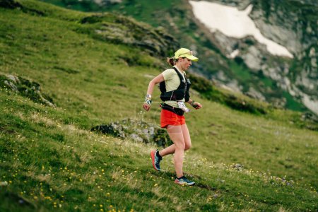 Photo for Arkhyz, Russia - July 2, 2022: female athlete running downhill in Arkhyz X Run - Royalty Free Image