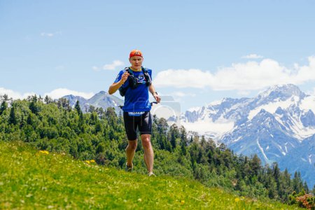 Photo for Arkhyz, Russia - July 3, 2022: male runner running mountain trail in Arkhyz X Run - Royalty Free Image