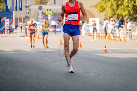 Photo for Male racewalker at distance in athletics competition - Royalty Free Image