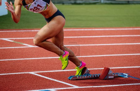 Photo for Sochi, Russia - October 6, 2022: legs female runner in spikes shoes Nike running starting blocks Polanik - Royalty Free Image