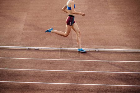 Photo for Chelyabinsk, Russia - June 4, 2022: runner girl in spikes shoes and shorts Nike running middle distance at stadium during UFD Athletics Championship - Royalty Free Image