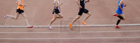 Téléchargez les photos : Chelyabinsk, Russia - June 4, 2022: group runners in spikes shoes Nike, Adidas and New Balance running middle distance at stadium during UFD Athletics Championship - en image libre de droit