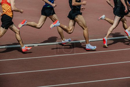 Photo for Chelyabinsk, Russia - June 5, 2022: group runners in spikes shoes Nike and Puma running middle distance at stadium during UFD Athletics Championship - Royalty Free Image