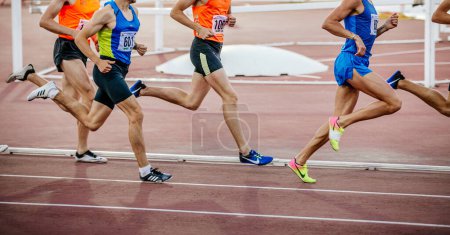Photo for Group runners athletes on middle distance run race, Nike and Adidas running spikes shoes, summer sports games - Royalty Free Image