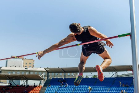 Photo for Male athlete high jump athletics competition, Nike jump spikes, sports editorial photo - Royalty Free Image