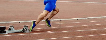 Photo for Legs male sprinter runner start running in starting blocks, athletics competition, summer sports games - Royalty Free Image