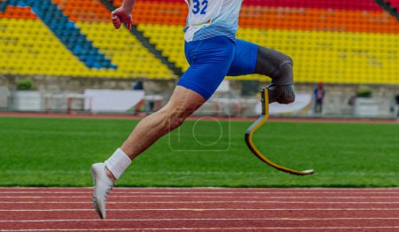 Photo for Athlete runner sprinter on prosthesis running stadium track, disabled athlete para athletics competition, summer sports games - Royalty Free Image