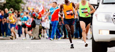 Photo for Two leading runners kenyan and european running marathon behind an escort car, jogger run world championships race - Royalty Free Image