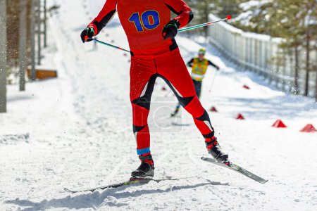 Téléchargez les photos : Athlète masculin skieur en montée au stade de ski, compétition de sports d'hiver - en image libre de droit