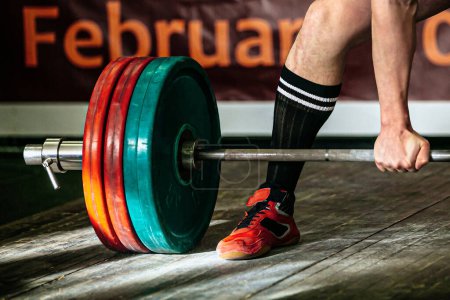 Photo for Part barbell and body powerlifter stand on wooden floor, powerlifting competition deadlift - Royalty Free Image