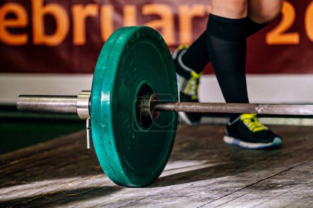 Photo for Part barbell and legs powerlifter on wooden floor, powerlifting competition deadlift - Royalty Free Image
