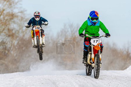 Photo for Two motocross rider riding winter off-road motorcycle racing - Royalty Free Image