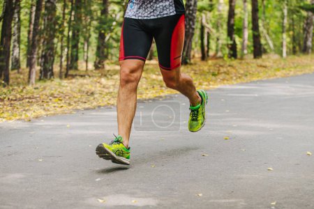 Photo for Legs male runner run marathon race in Asics running shoes - Royalty Free Image
