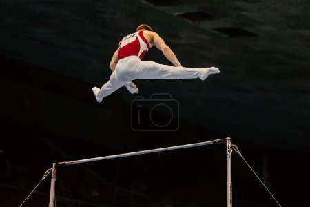 Photo for Male gymnast exercise on horizontal bar in artistic gymnastics. apparatus company Spieth Germany - Royalty Free Image