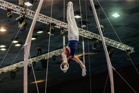 Photo for Gymnast exercise on ring frame in gymnastics summer games, apparatus company Spieth Germany - Royalty Free Image