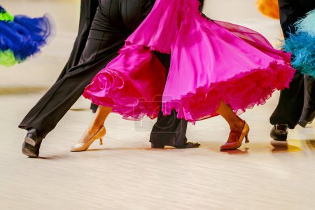 Téléchargez les photos : En gros plan partie robe de bal rose et costume homme queue noire sur la piste de danse - en image libre de droit