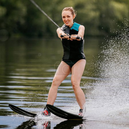 Photo for Young woman with mysterious look riding water skiing on pond, joy summer vacation - Royalty Free Image