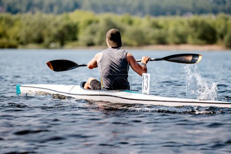 Photo for Back kayaker athlete on kayak single in kayaking championship race, sports summer games - Royalty Free Image