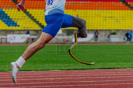 Photo for Male runner para athlete on limb deficiency running track stadium, summer para athletics championships - Royalty Free Image