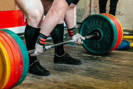 Photo for Athlete powerlifter performing deadlift heavy barbell at powerlifting competition, power sports games - Royalty Free Image