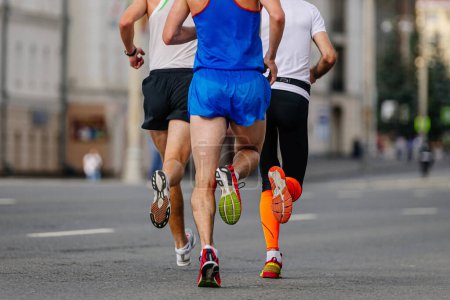 Photo for Rear view three runners athletes running marathon in city, group male jogger summer sports race - Royalty Free Image