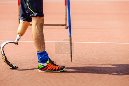 Photo for Leg on prosthesis male athlete with spear at athletics championships, summer para sports games - Royalty Free Image