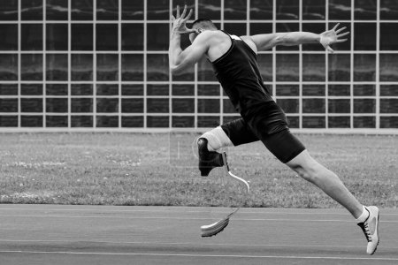 Photo for Man athlete disability running sprint race at athletics competition, black and white photo - Royalty Free Image