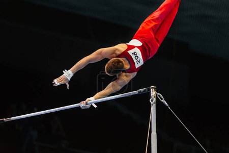 Foto de Gimnasta ejercicio barra horizontal en el campeonato de gimnasia, elemento zou li min - Imagen libre de derechos