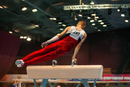 Photo for Gymnast exercise pommel horse in championship gymnastics, element circle A - Royalty Free Image