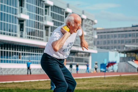 Photo for Chelyabinsk, Russia - August 28, 2015: senior man athlete shot put in masters athletics summer competition - Royalty Free Image